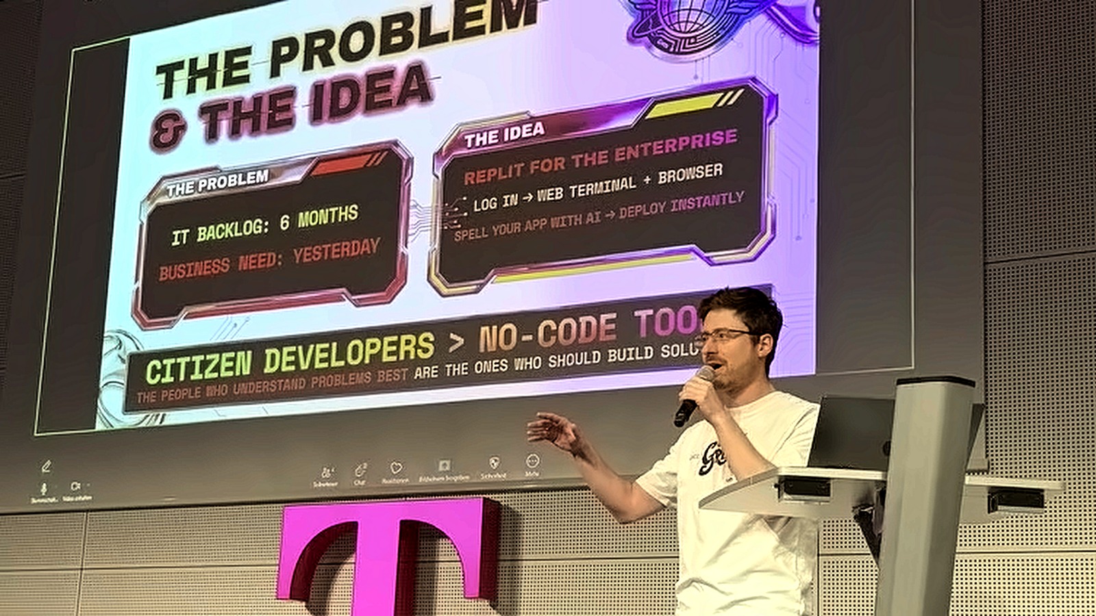 Presenting in front of the problem and the idea slide, gesturing towards the screen